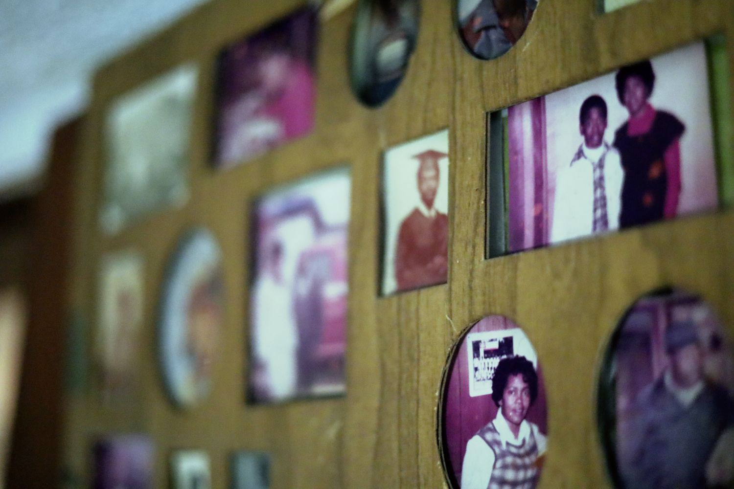 A wall of framed family photographs