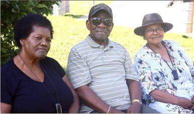 Three elders seated outdoors